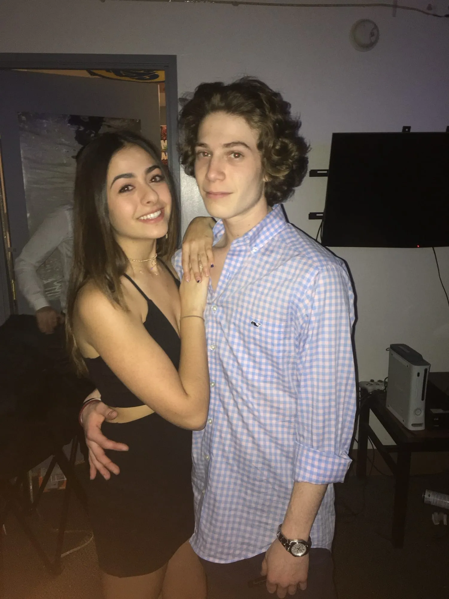 Lauren and Ben with their arms around each other at a house party