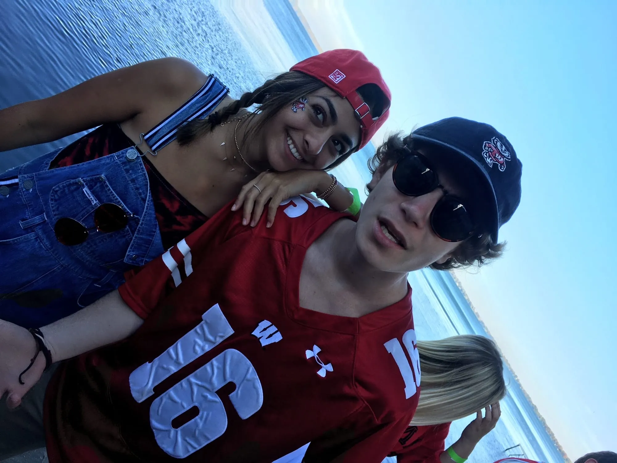 Ben and Lauren in Wisconsin jerseys and caps on the lakeshore