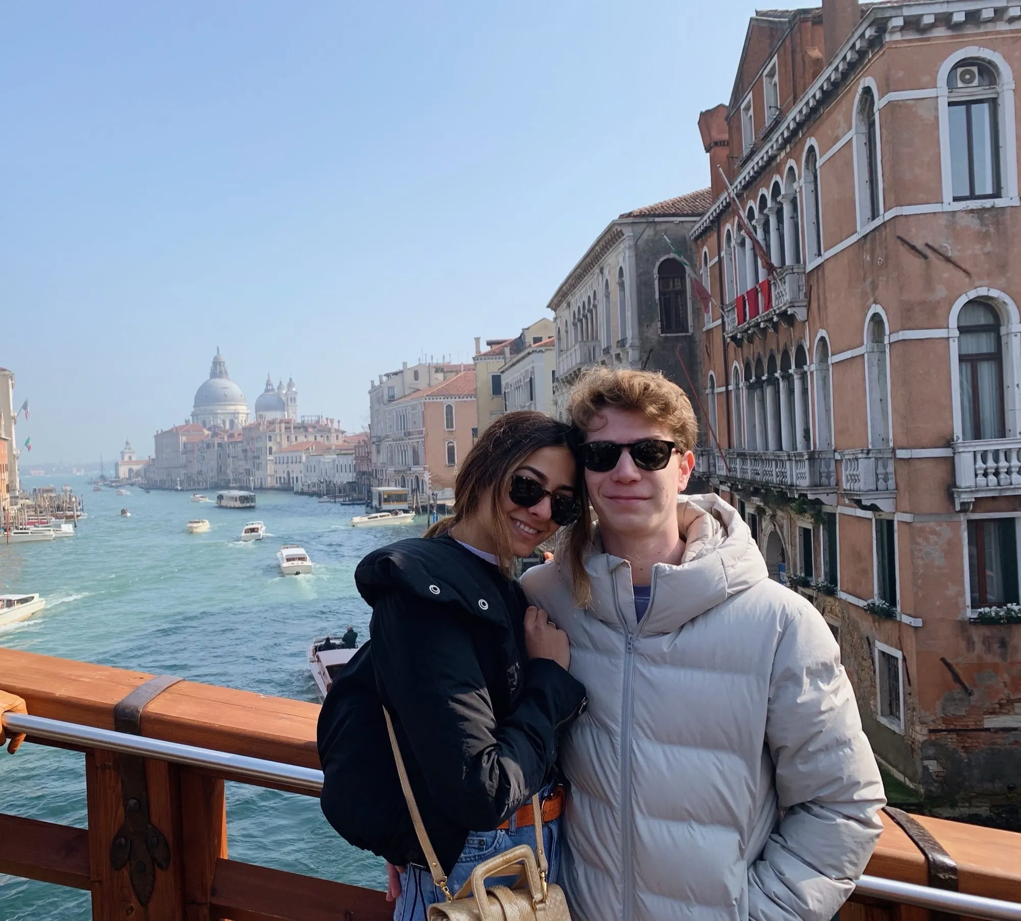 Lauren and Ben in winter coats on the Grand Canal in Venice