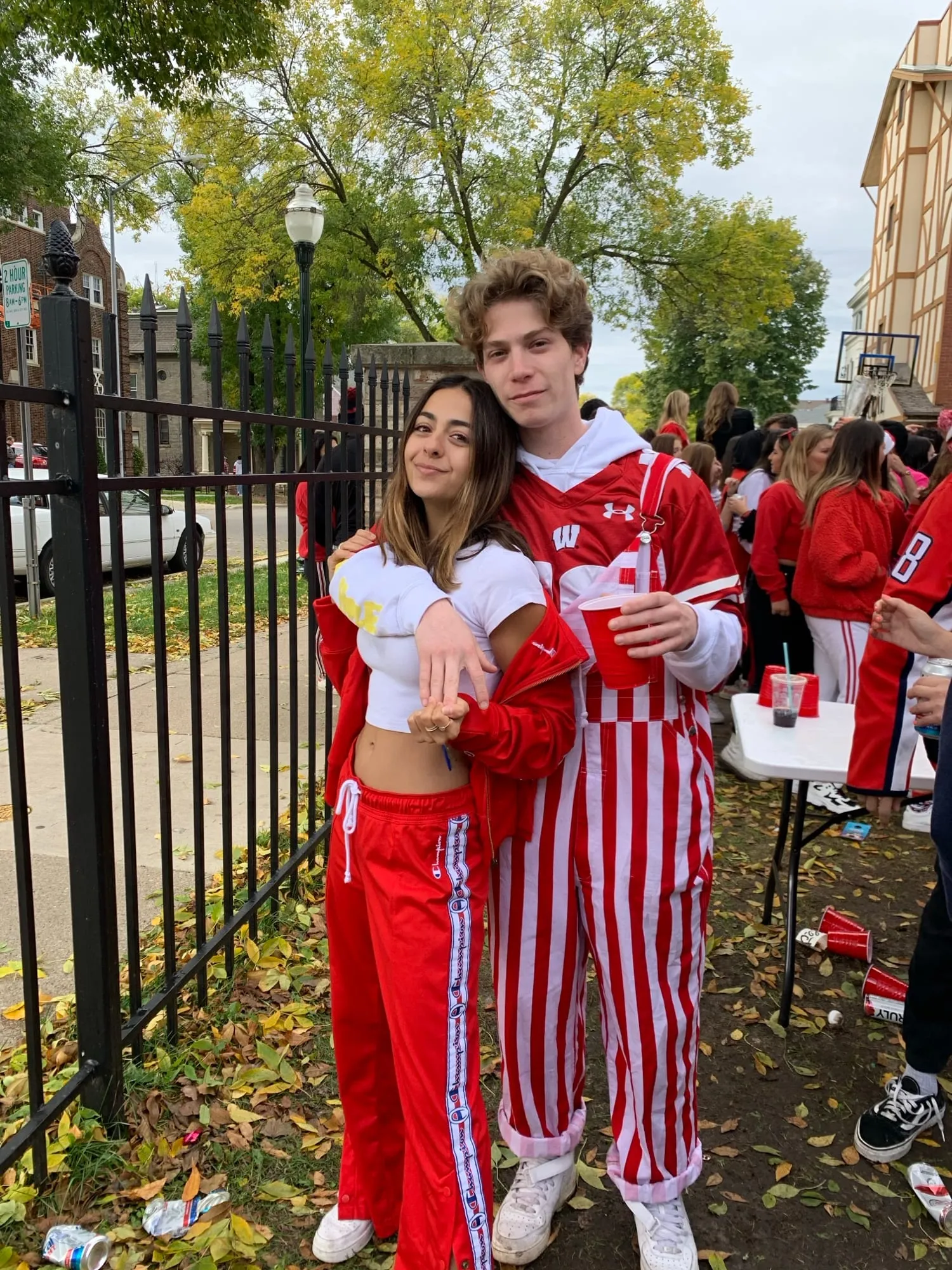 Lauren and Ben in red and white striped overalls on game day