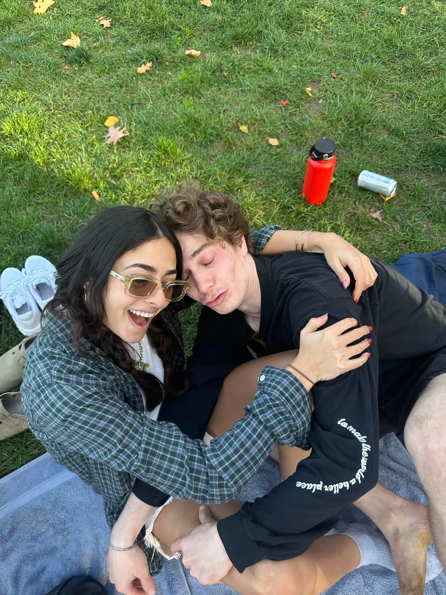 Lauren and Ben lying together on a blanket on the grass