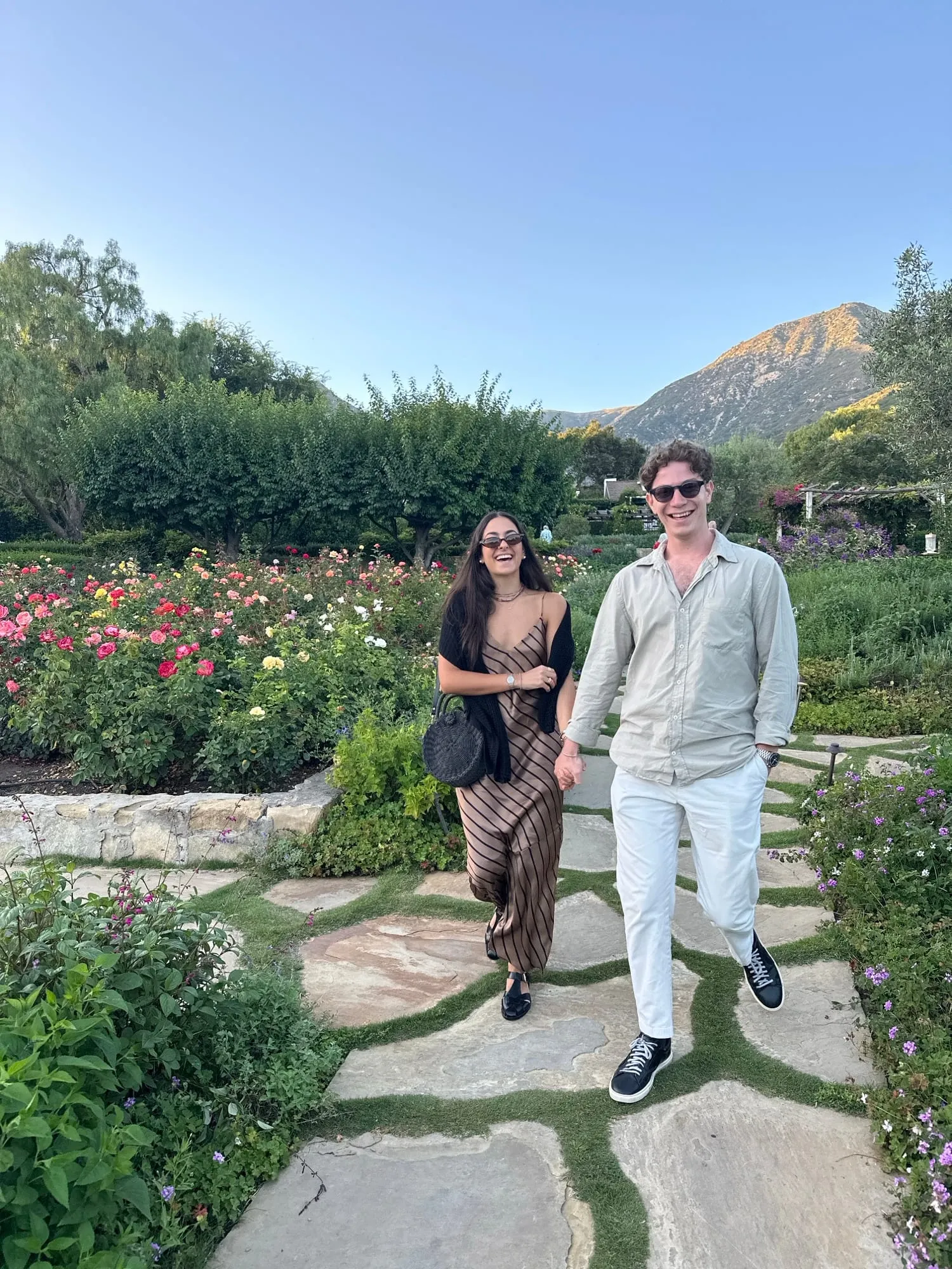 Lauren and Ben on a garden path with the foothills behind them