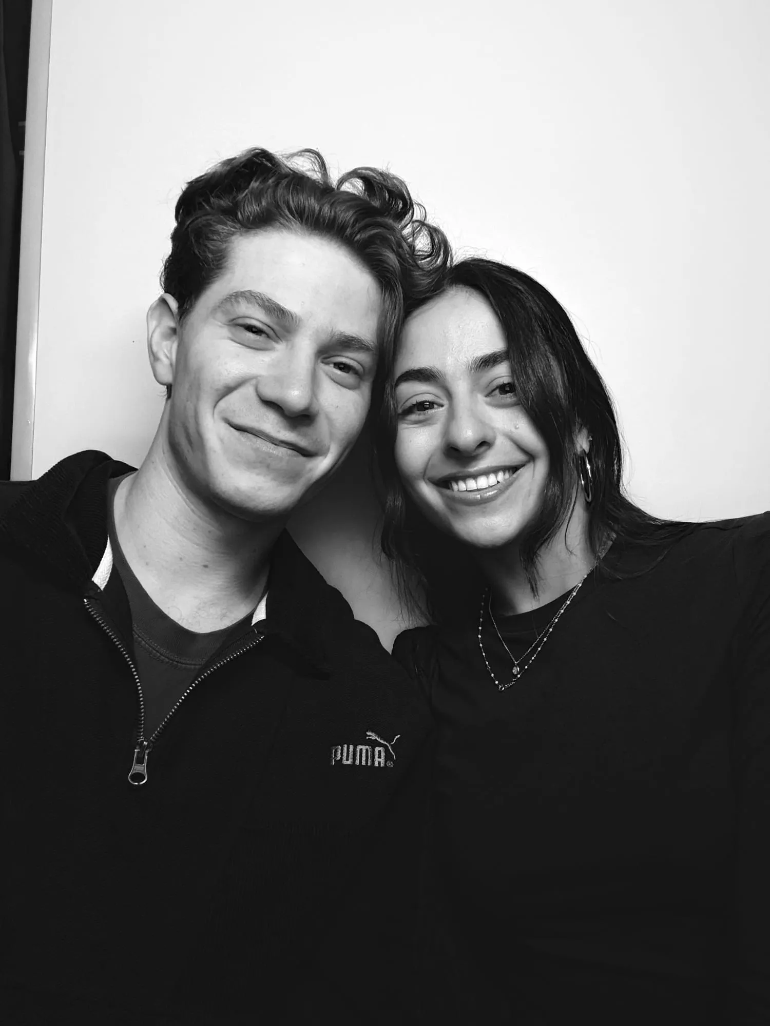 A black and white portrait of Lauren and Ben cheek to cheek