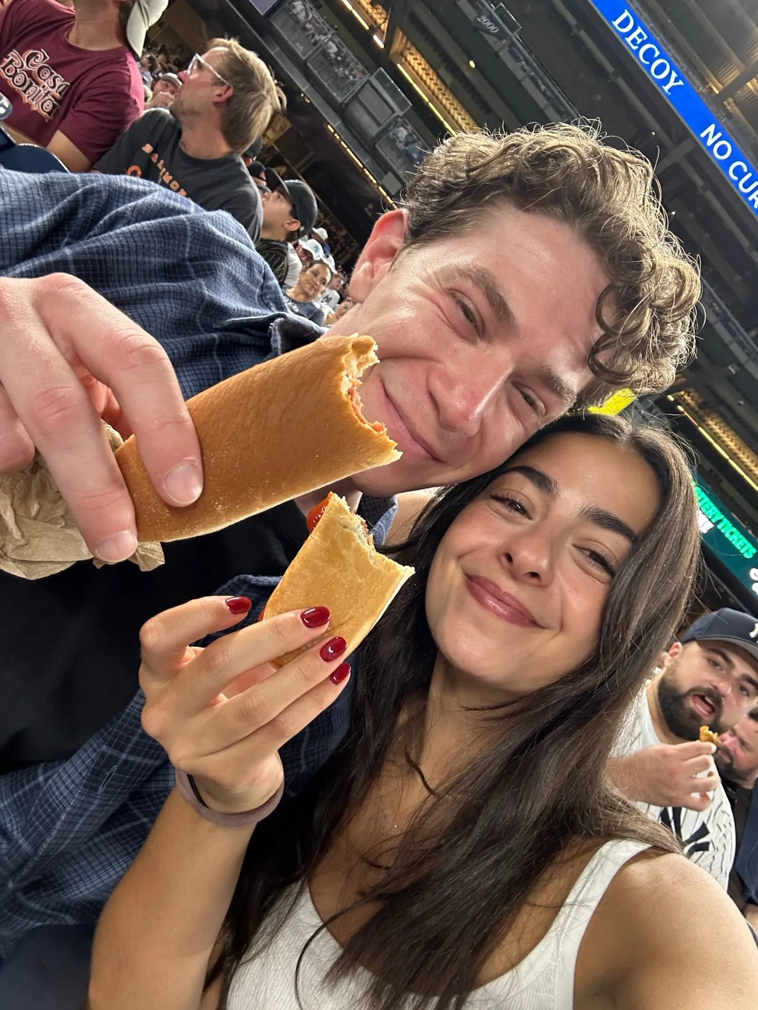 Lauren and Ben sharing street food on a city sidewalk at night