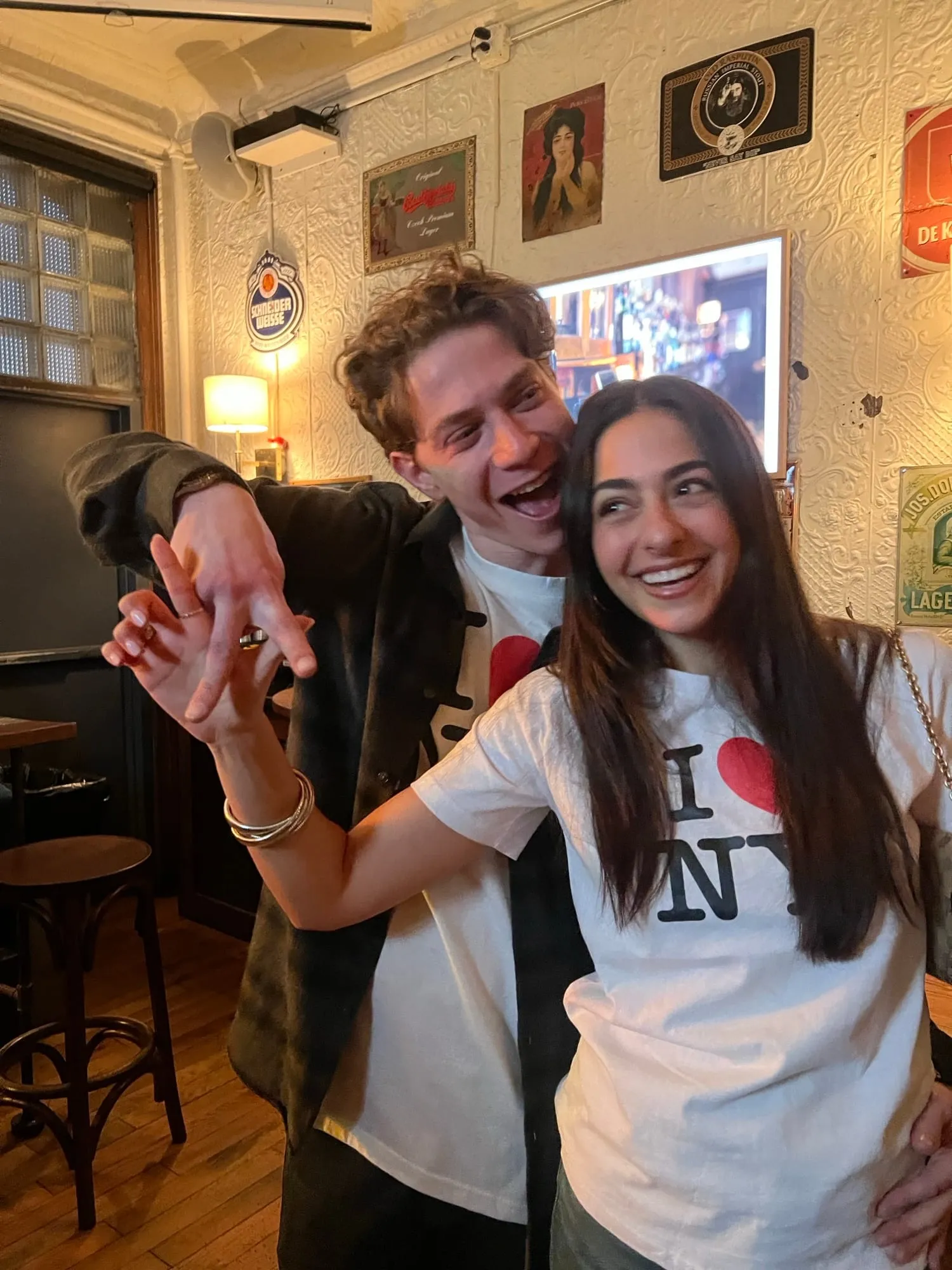 Lauren and Ben in I heart NY shirts in a wood-panelled bar