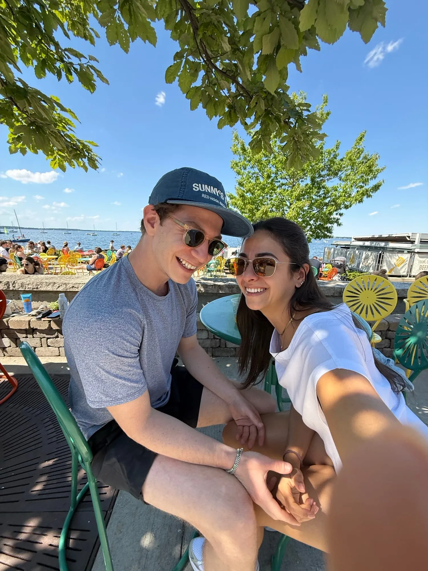 A summer selfie of Lauren and Ben on a waterfront terrace