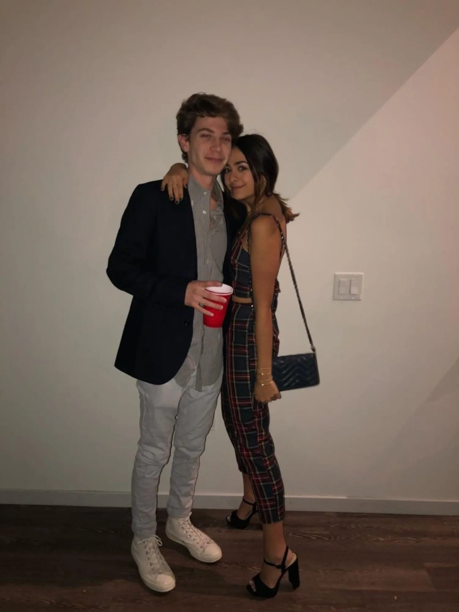 Lauren and Ben dressed up at a party, his arm around her